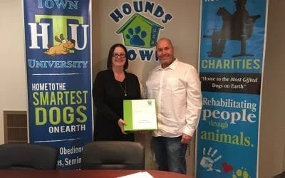 Hounds Town franchise owners holding a certificate