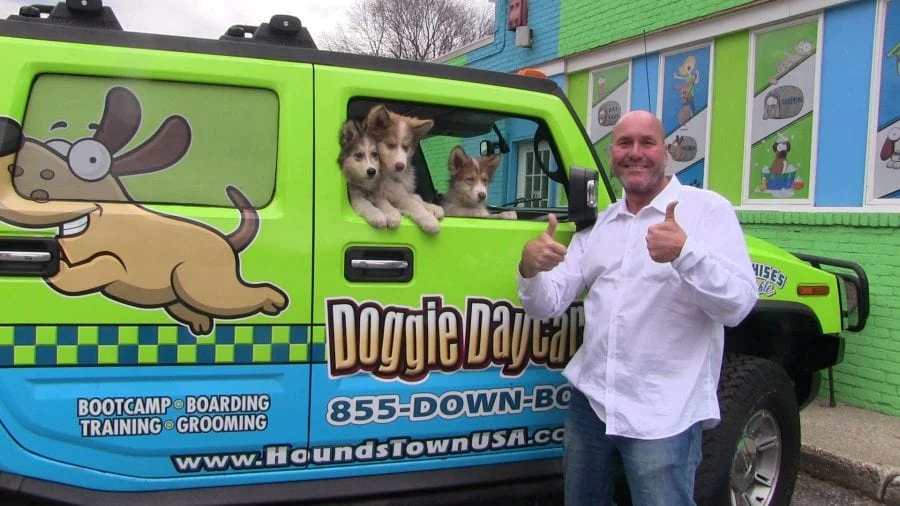 Man gives thumbs up next to a H