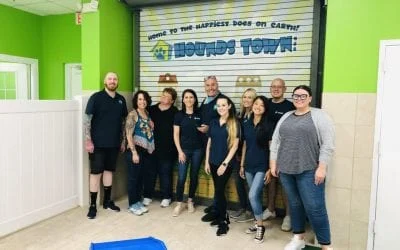 Smiling team of owners and staff at a new H