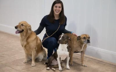 Smiling woman with a golden retriever, brindle