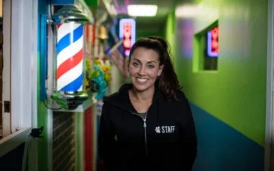 Smiling Hounds Town staff member in a black hoodie