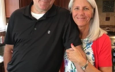 Brian and Kathy Martin, smiling Hounds Town dog