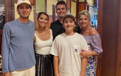 Smiling family of five, including a mother and