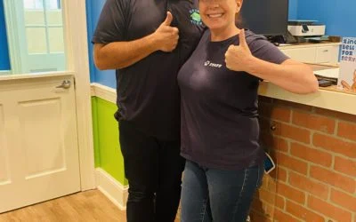 Two Hounds Town USA staff members giving thumbs up