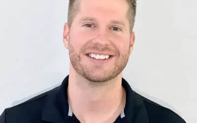 Eric Steinke smiling, wearing a black polo shirt