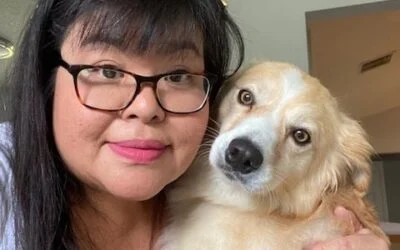 Smiling woman with glasses holding her light brown