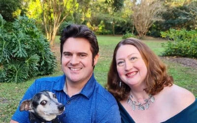 Smiling man and woman holding a small