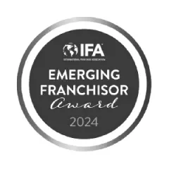 Hounds Town's 2024 Emerging Franchisor Award badge from the International Franchise Association.
