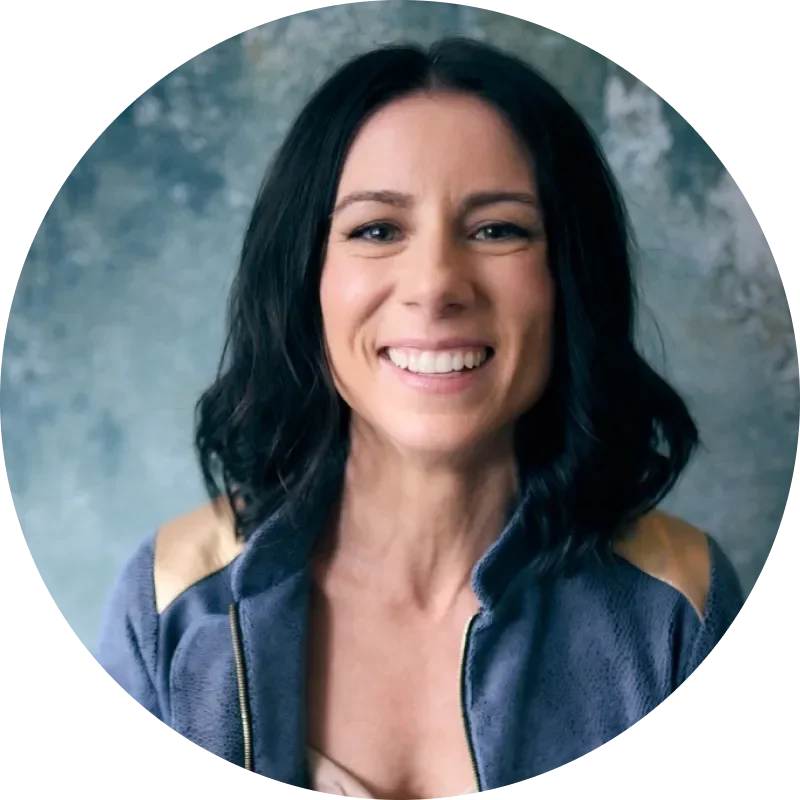 Smiling woman with dark hair in a blue jacket,